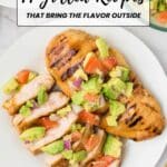 Grilled chicken breast topped with avocado and tomato salsa, sliced and served on a white plate, with a bowl of salsa in the background. Text overlay reads "14 Grilled Recipes.