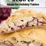 Close-up of a sliced pastry filled with chicken and cranberries on a white plate, with cranberry sauce and parsley in the background. Text reads: "15 Cranberry Recipes Made for Holiday Tables.