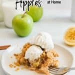 A plate with apple crumble topped with two scoops of vanilla ice cream, a fork, and two green apples and a halved lemon in the background. Text overlay reads: "16 Clever Ways to Use Up Those Extra Apples at Home.