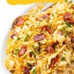 A plate of cooked cabbage mixed with bacon pieces and garnished with chopped parsley, accompanied by a spoon. Text reads "16 Low-Carb Recipes That Actually Satisfy.