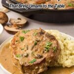 A plate with a pork chop in mushroom gravy, garnished with herbs, served alongside mashed potatoes; text reads "16 Mushroom Recipes That Bring Umami to the Table.