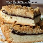 Two crumbly dessert bars with a visible layer of Nutella filling are stacked on a patterned cloth, promoting Nutella dessert recipes.