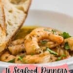 A bowl of shrimp in sauce garnished with herbs, served with two slices of bread. Text reads: "16 Seafood Dinners That Feel Restaurant-Worthy.
