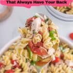 A spoonful of rotini pasta salad with chicken, tomatoes, spinach, and herbs held above a bowl of the same dish. Text reads "11 Pasta Dinners That Always Have Your Back.