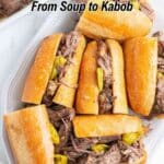 Sandwiches filled with shredded beef and pepperoncini peppers are arranged on a platter. Text reads, "17 Ways to Cook Beef From Soup to Kabob.