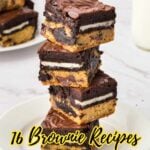 A stack of unique brownies with chocolate, cookie, and Oreo layers sits on a white plate, with more brownies and a glass of milk in the backgroundโperfect for anyone seeking fun new brownie recipes.