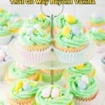 Tiered cupcake stand with pastel green frosted cupcakes decorated with candy eggs and sprinkles, surrounded by more cupcakes. Text reads: "18 Cupcake Recipes That Go Way Beyond Vanilla.