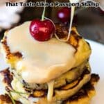 A stack of pancakes topped with sauce and a cherry, with text promoting "19 European Recipes That Taste Like a Passport Stamp.