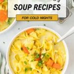 A bowl of noodle soup with vegetables and herbs sits on a table with a spoon, accompanied by text promoting 19 warm and cozy soup recipes for cold nights.