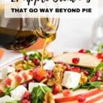 A hand pours dark dressing onto a salad with apple slices, walnuts, pomegranate seeds, and feta cheese in a glass bowl. Text reads: "21 Apple Creations That Go Way Beyond Pie.