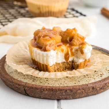 A mini caramel apple cheesecake on a plate.