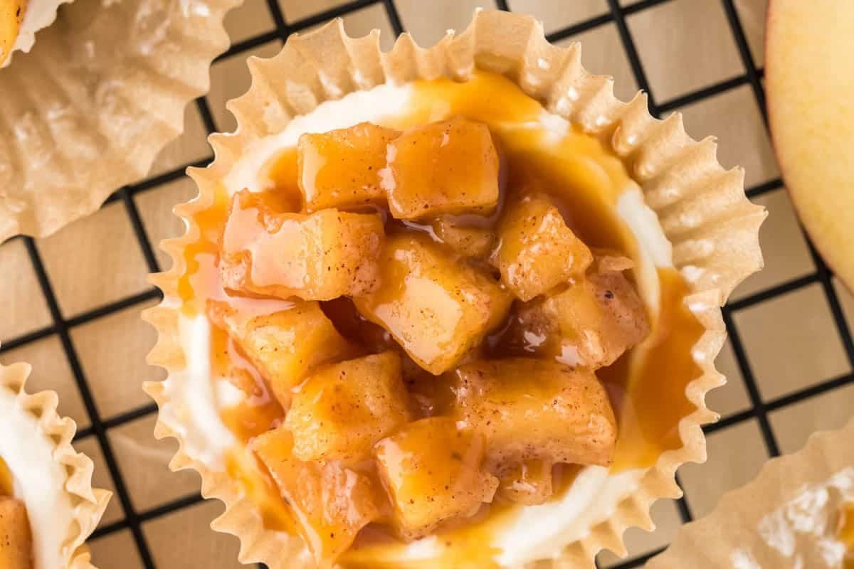 Creamy, caramel-drizzled mini cheesecakes topped with warm spiced apples