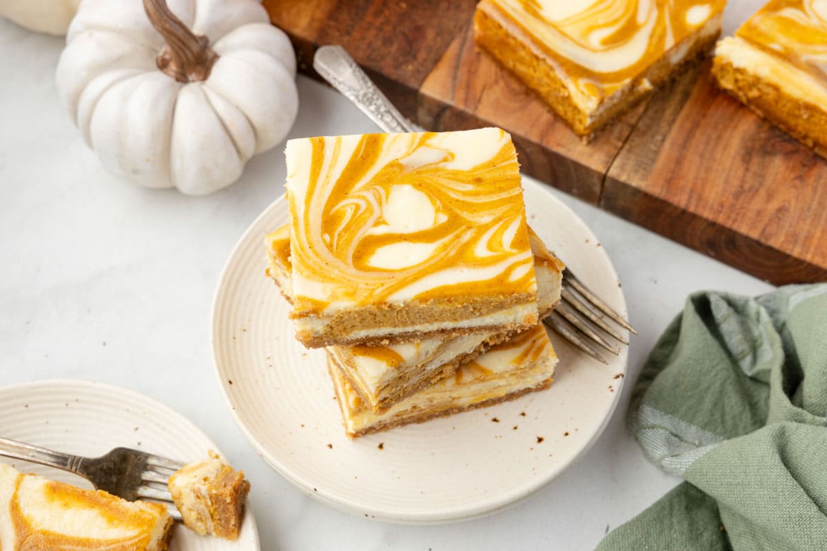 Creamy, spiced Pumpkin Cheesecake Bars with a buttery graham crust — your new favorite fall dessert!