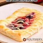 A rectangular fruit danish with icing drizzle sits on a plate; text reads "10 Danish Recipes That Bake With Structure" with the Southern logo at the bottom.
