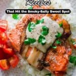 A plate of bacon-wrapped salmon served on white rice, topped with herbs, with sliced tomatoes on the side. Text overlay reads, "13 Bacon Wrapped Recipes.