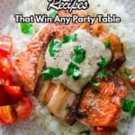 A plate of bacon-wrapped salmon topped with sauce and parsley, served on a bed of rice with cherry tomato slices on the side. Text reads "13 Bacon-Wrapped Recipes That Win Any Party Table.