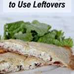 A plate with two halves of a baked pastry filled with meat, served with leafy greens. Text above reads "13 Creative Ways to Use Leftovers.