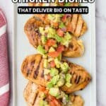 Grilled chicken breasts topped with chopped avocado, tomato, and onion on a white rectangular plate, with the text โ13 Low-Carb Chicken Dishes That Deliver Big on Taste.โ.