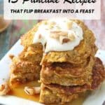 A stack of pancakes topped with whipped cream and chopped nuts, drizzled with syrup, sits on a rustic wooden surface. Text reads: "13 Pancake Recipes That Flip Breakfast Into a Feast.