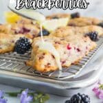 A hand drizzles icing over blackberry scones on a cooling rack, with blackberries, lemon slices, and flowers around them. Text reads: "13 Sweet Ways to Bake with Blackberries.