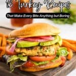 A turkey burger with lettuce, tomato, avocado, and pickled onions in a bun, served with sweet potato fries on a wooden tray. Text overlay reads "13 Turkey Recipes.