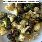 A plate of roasted broccoli and cauliflower sits on a light-colored surface. Text on the image reads: "14 Side Dish Recipes That Prove the Air Fryer Can Do It All.