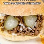 A sandwich with ground meat, chopped onions, and pickle slices in a bun is pictured next to potato chips. Text reads "15 Creative Sandwiches That Go Beyond the Basics.