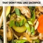 A bowl of vegetable stir fry with noodles, broccoli, carrots, zucchini, mushrooms, and chopsticks. Text reads, “16 Dairy-Free Recipes That Don’t Feel Like Sacrifice.”.