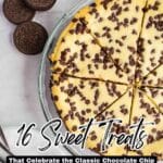 A sliced chocolate chip cheesecake in a glass dish sits next to stacked chocolate sandwich cookies and metal forks on a light surface.