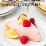 A slice of raspberry pie with lemon wedges and raspberries on a white plate, with dessert forks and a pie in the background. Text overlay reads, "17 Berry-Filled Desserts for Raspberry Fans.