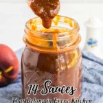 A glass jar filled with brown sauce sits on a blue cloth, with a wooden spoon lifting sauce above it; text reads "14 Sauces That Belong in Every Cooking Kitchen.