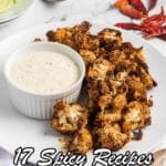 A plate of roasted cauliflower with a side of dipping sauce, garnished with celery and dried red chilies, promoting 17 spicy recipes.