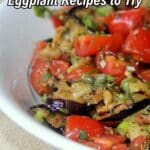 A bowl of cooked eggplant mixed with chopped tomatoes and herbs, with text overlay reading "18 Flavor-Forward Eggplant Recipes to Try.