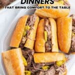 A plate of sandwiches filled with shredded beef and peppers on a white surface, with text reading, "18 Hearty Beef Dinners That Bring Comfort to the Table.