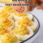 A hand sprinkles paprika on a plate of deviled eggs with piped filling. Text reads, "19 Deviled Egg Recipes That Never Disappoint.