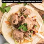 A soft taco filled with chunks of cooked pork and shredded vegetables, garnished with cilantro, on a wooden board. Text reads "20 Pork Dinners" and "Southern Food and Fun.