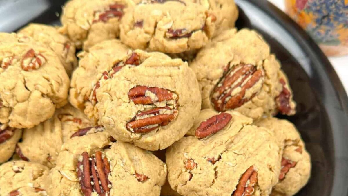 A plate of oatmeal cookies topped with whole pecans, arranged closely together—perfect for stress-free Christmas baking or adding to your collection of easy Christmas recipes.
