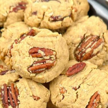 A plate of oatmeal cookies topped with whole pecans, arranged closely togetherโperfect for stress-free Christmas baking or adding to your collection of easy Christmas recipes.