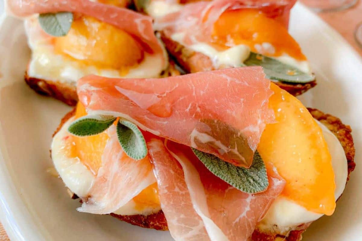 Slices of toasted bread topped with creamy ricotta, melted cheese, peach slices, prosciutto, sage leaves, and a drizzle of honey make this an irresistible addition to your collection of easy ricotta recipes.