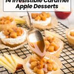 A spoon drizzles caramel sauce over a mini apple dessert topped with caramelized apples, set on a cooling rackโan irresistible treat for fans of caramel apple desserts. Apple slices are scattered nearby for a fresh touch.