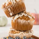 Three crumb-topped muffins stacked on a plate with white icing drizzle, accompanied by text promoting 13 muffin recipes that deliver irresistible, bakery-level texture.