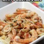 A bowl of cooked shrimp mixed with sliced onions and herbs, with text reading "16 Shrimp Recipes With Coastal Vibes" at the top.