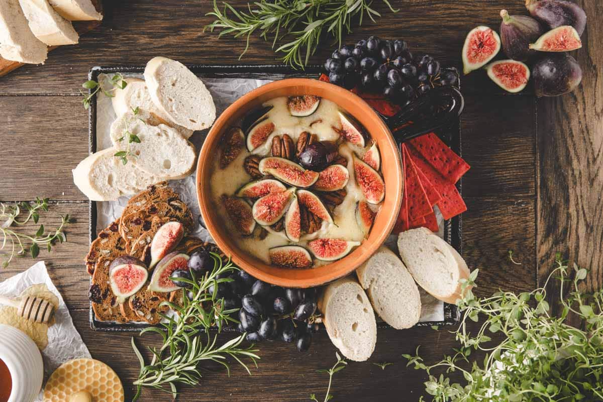 Creamy Brie fondue with figs, pecans, and honey—a sweet and savory delight for entertaining or cozy.