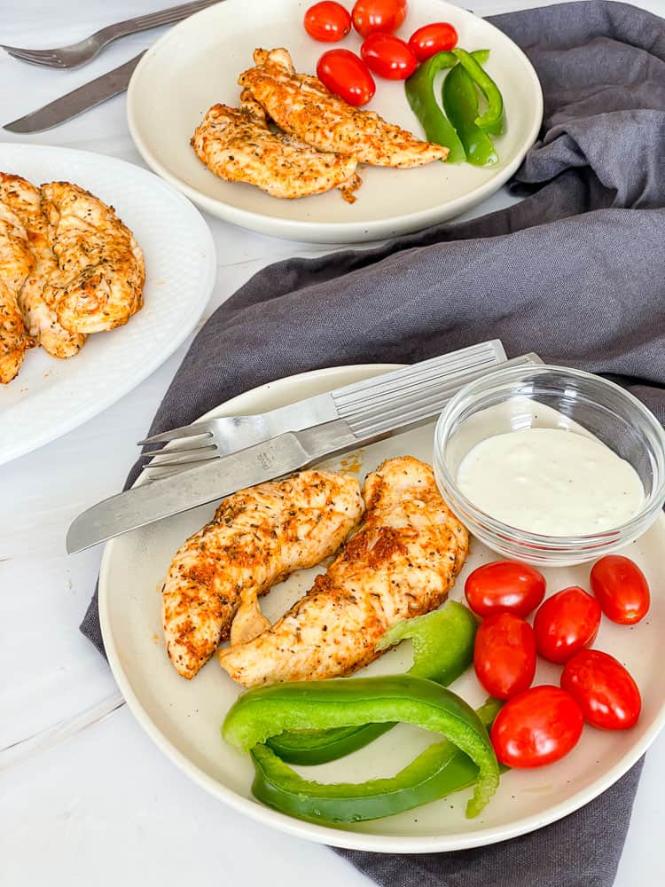 A bowl of stir-fried beef with vegetables served over white rice, perfect for those seeking gluten free dinner recipes, with chopsticks resting on the bowl and scallions and a napkin nearby.