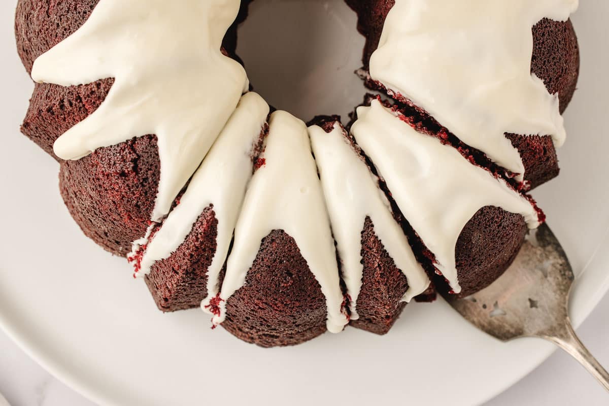 A rich, moist Red Velvet Bundt Cake topped with creamy cheese glaze — easy to bake.