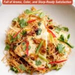 A plate of stir-fried noodles topped with sliced tofu, red and green chilies, and cilantro, with text promoting 14 Asian dinner recipes.