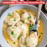 A bowl of chicken covered in creamy cheese sauce, garnished with chopped parsley, with a serving spoon resting in the dish. Text overlay reads "15 Cream Cheese Recipes.