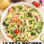 A bowl of orzo salad with cherry tomatoes, cucumber, red onion, olives, spinach, and creamy feta, surrounded by fresh vegetables and a jar of dressing. Text: "15 Feta Recipes - Bursting With Salty, Creamy Flavor.