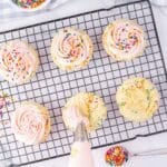 A baking tray with cupcakes and sprinkles.