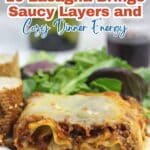 A slice of lasagna on a plate with salad and bread, with text promoting lasagna recipes for cozy dinner energy.